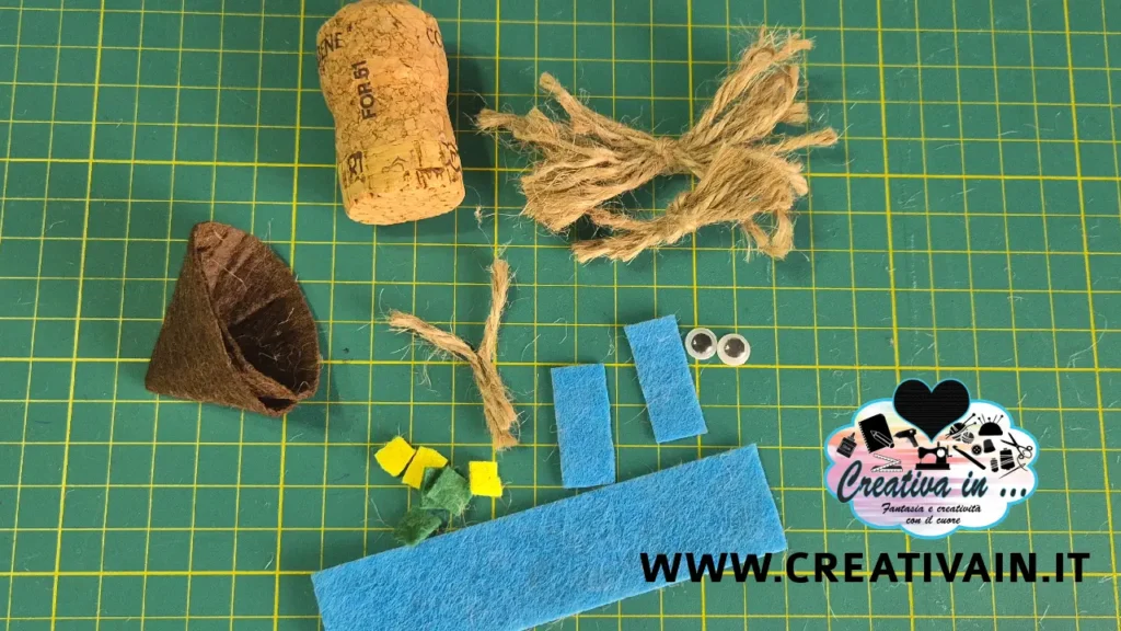 Componenti ritagliati per lo spaventapasseri in sughero: cappello a cono, giacca in pannolenci e fili di spago.